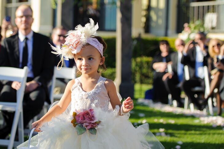 "Our three flower girls and nieces were decked out in dresses and accessories with tulle, lace, feathers and pearls," the couple says. "All three flower girls were under age 5, and they did so well walking down the aisle."