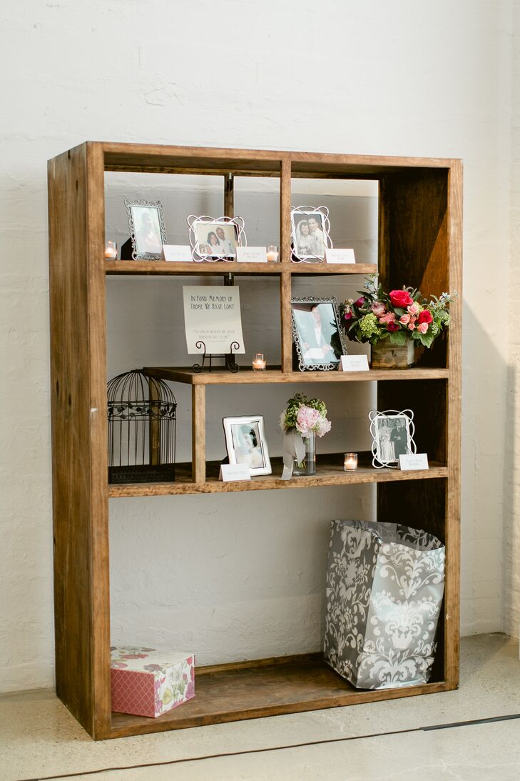 A photo display of family members who had died—including Jav's mother and godmother—was set up near the gift area. In addition to framed photos, tealights and floral arrangements, this quote was also on the shelf: "To live in hearts we left behind is not to die."