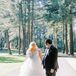 Bride in Tulle Gown With V-Neckline and Groom in Tuxedo in Forest