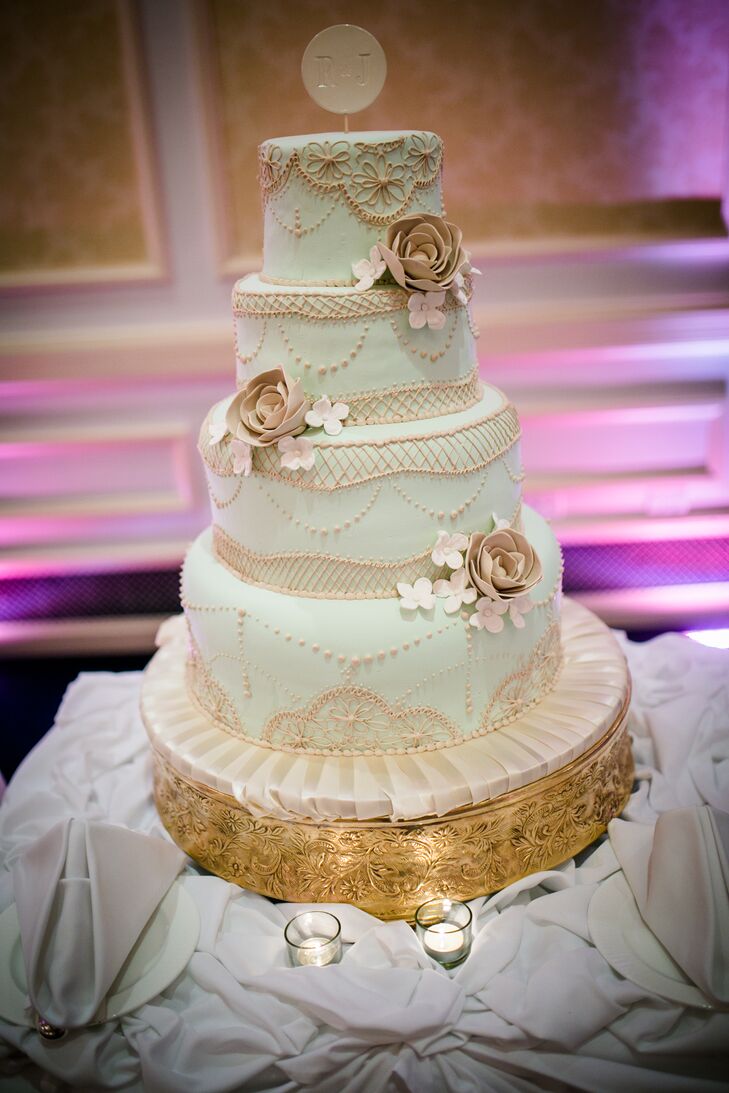 Rebecca and Jonathan worked with Konditor Meister to design a wedding cake that was as beautiful as it was delicious. The four-tier confection was covered in pale-mint-colored fondant and featured lattice and lace-inspired piping, as well as vintage-inspired sugar blooms. The couple completed their cake’s design with a simple monogrammed accent.