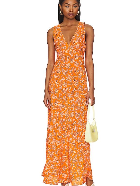 Model wearing an orange floral dress with a deep v-neckline