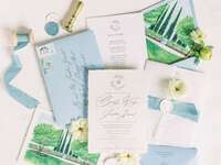 Wedding flatlay of accessories including stationery, flowers and details