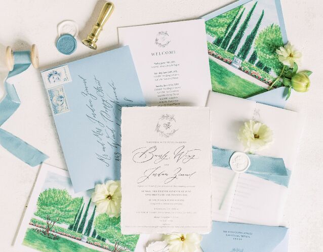 Wedding flatlay of accessories including stationery, flowers and details