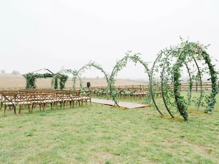 Steel Hoop Aisle Arches Covered in Eucalyptus and Greenery