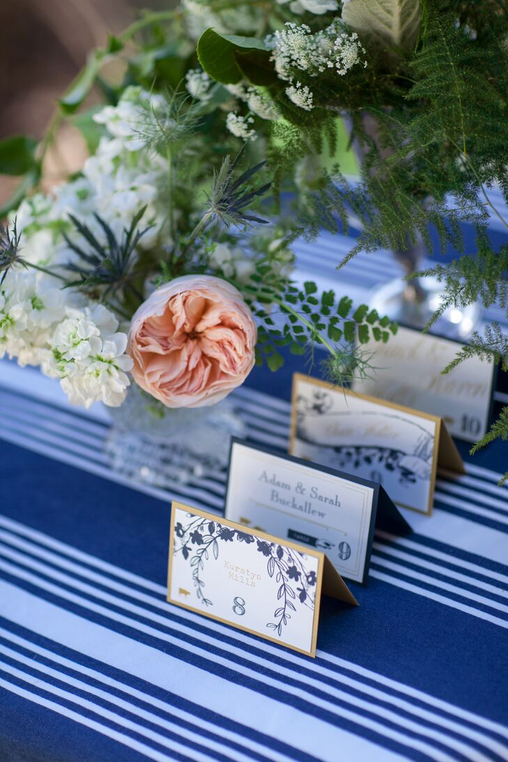White escort cards had navy designs printed of them, and were bordered with gold or blue.