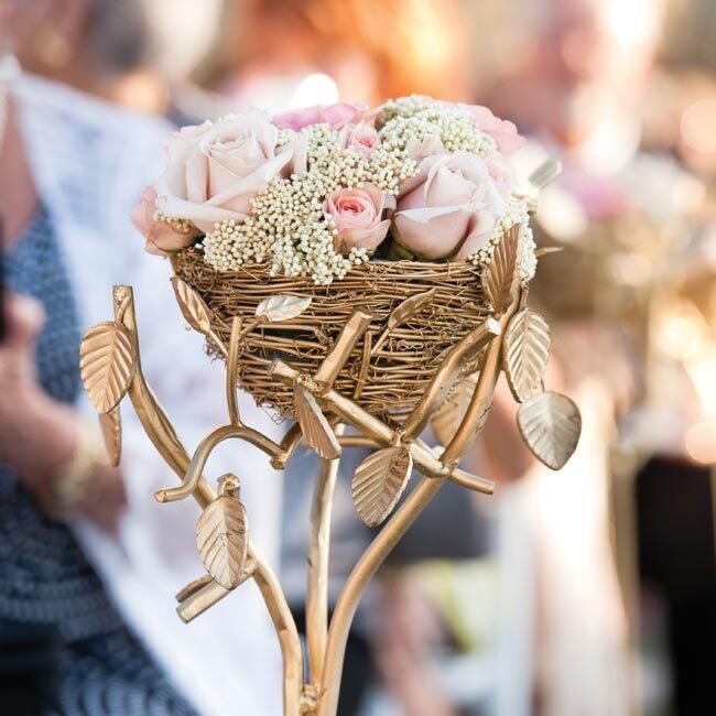 Gold bird nests filled with roses topped some of the cocktail tables.