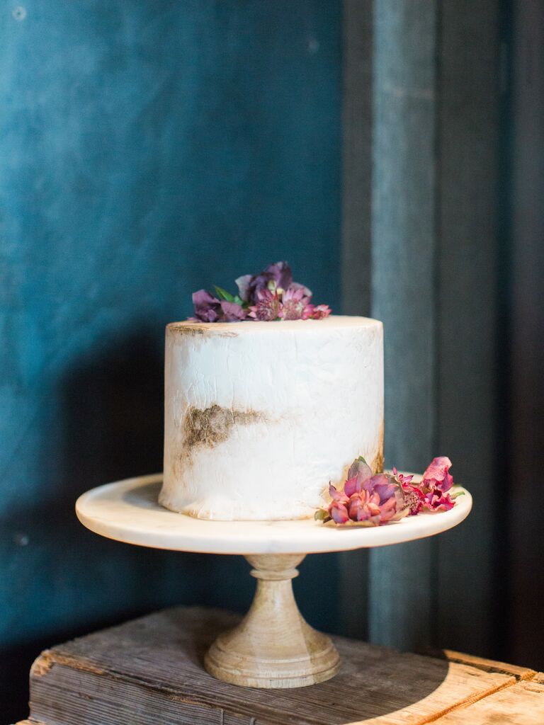 modern one tier wedding cake with white and brown marble design and purple flowers