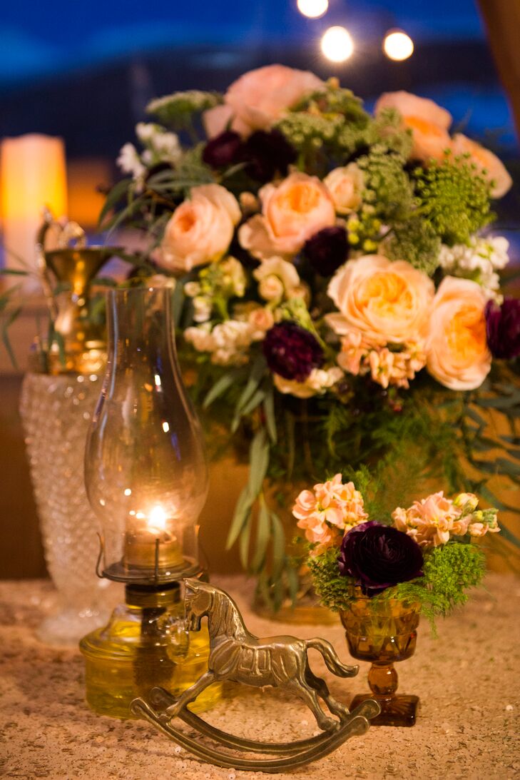 To match the whimsical fox caricature invitations, Kristen and Sean added gold animal figurines to their centerpieces