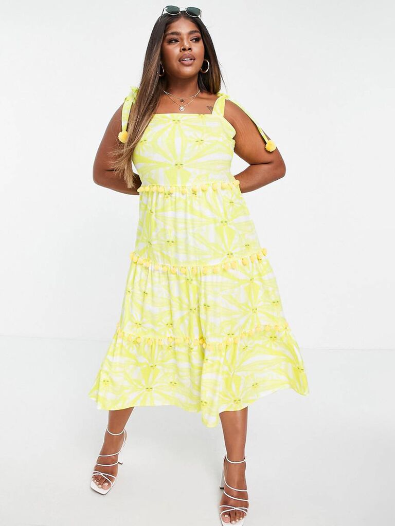 asos yellow and white pastel midi dress for wedding guests with sun print and pom pom details