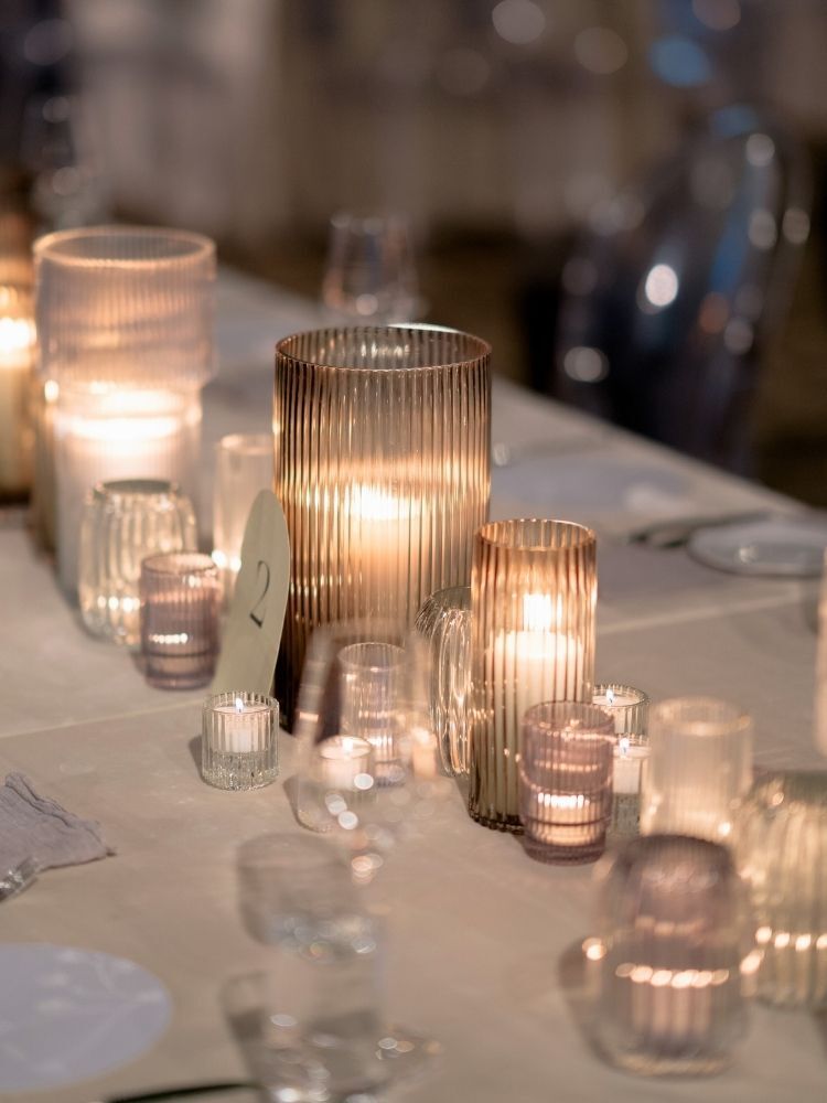 pillar candles in gray glass hurricanes