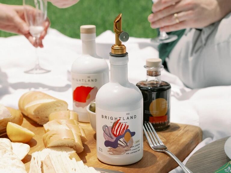 Various bottles of delicious infused olive oils displayed at an outdoor picnic. 