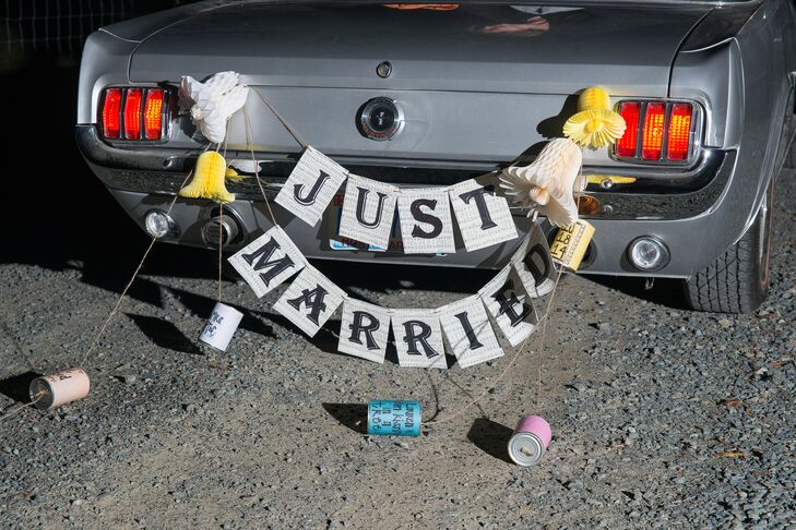 The newlyweds drove off in a vintage convertible decorated with a retro "Just Married" banner complete with tin cans.