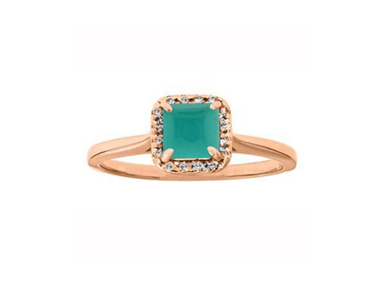 Princess turquoise center stone bordered by diamonds on gold band