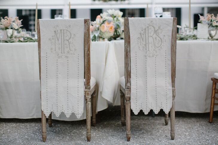 Nina's and Tristan's chairs were decorated with "Mrs." and "Mr." cloth linens with gray polka dots. The ivory drapery matched the bengaline table linens from Nuage Linens. "I absolutely loved the Nuage Linens," Nina says. "They were actually the inspiration for a lot of our decor."