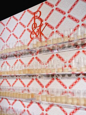 Champagne Flute Wall With Red Patterned Backdrop