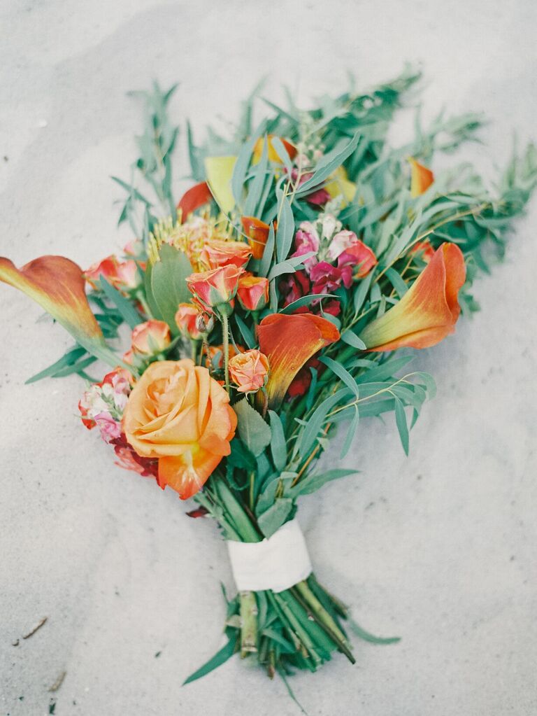 unique fall wedding bouquet with orange roses, calla lilies and greenery