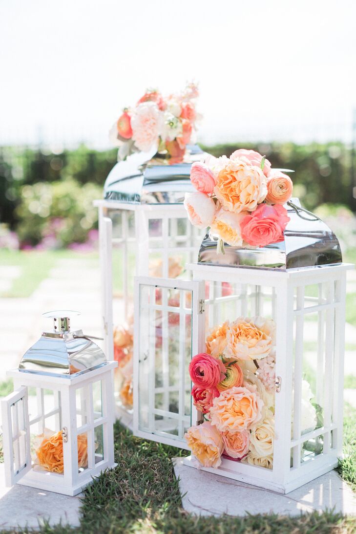 Wanting to highlight the beach club’s natural beauty, they kept all ceremony decor to a minimum. Only two sets of modern white and silver lanterns marked the ceremony space so everyone had an unobstructed waterfront view. Isn't She Lovely Florals made the accents pop with coral and pink ranunculus, peach and blush garden roses, as well as ivory roses.