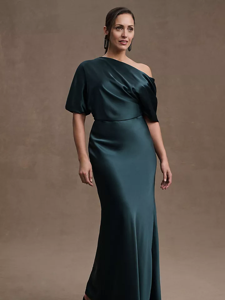 A model wears this off-the-shoulder jewel-toned mother of the bride gown.