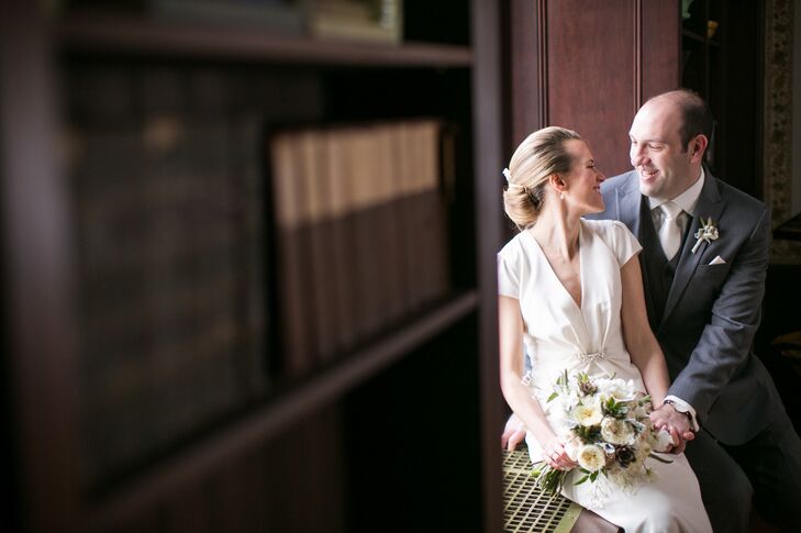 Edith wanted simple and classic when it came to her wedding day look. She spotted her Nicole Miller gown at Vows Bridal Outlet and was instantly taken by its elegant sheath style, cap sleeves, v-shaped neckline and gathered detailing at the bodice, which lent the dress a vintage-glam vibe. “I wanted my accessories to match the crystal embellishment on my dress,” says Edith. “My shoes were ivory satin flats with crystals on the toes. I did not want to wear a veil, since our look was more casual, so I had a hairpiece custom designed,” says Edith. “For jewelry, with my hairpiece and the detail on my dress, I decided I only needed a simple pair of diamond and pear drop earrings. I also wore a silver cuff bracelet, which had belonged to my grandmother.”