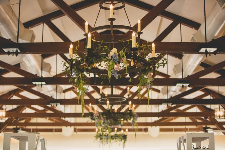 Jenna and Joshua decorated the candelabra chandeliers with hanging amaranthus, pink roses and blue stock flowers. The exposed wood beams across the cathedral ceiling of the hall matched perfectly with their lowcountry theme.