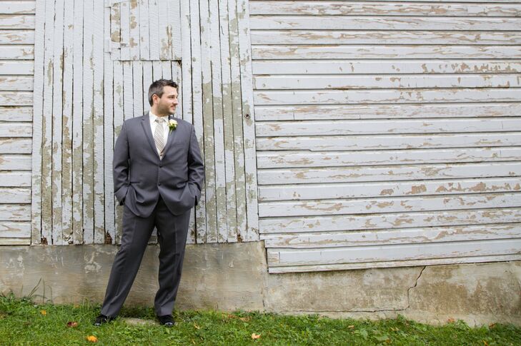 Patrick dressed in a gray tuxedo with a light gold vest and a striped black, ivory and gray tie.