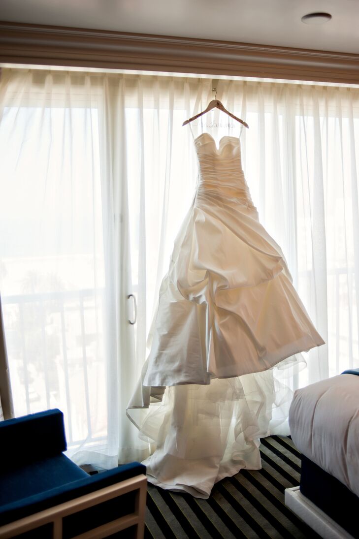The bride wanted a simple sweetheart ball gown without a lot of embellishment but a lot of volume. She wore a white satin ball gown by Enzoani with gathered details and a train.