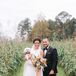 Bride and Groom Posing With Dogs on Farm in Chadbourn, North Carolina