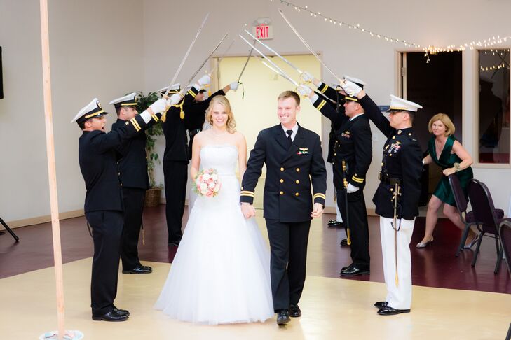 “A special military tradition, which occurred when we were being announced as a couple, was the sword arch,” says the couple. “Charles's military buddies formed two lines and crossed their swords in between. The newlyweds had to walk under an arch of these swords as they were introduced. As they approached each set of swords the officers would lower their swords, and demand, "A Kiss to Pass" to much applause! At the last sword, Charles's best man swatted Micaela's bottom with the sword, and loudly announced "WELCOME TO THE NAVY, MRS. JONES."”