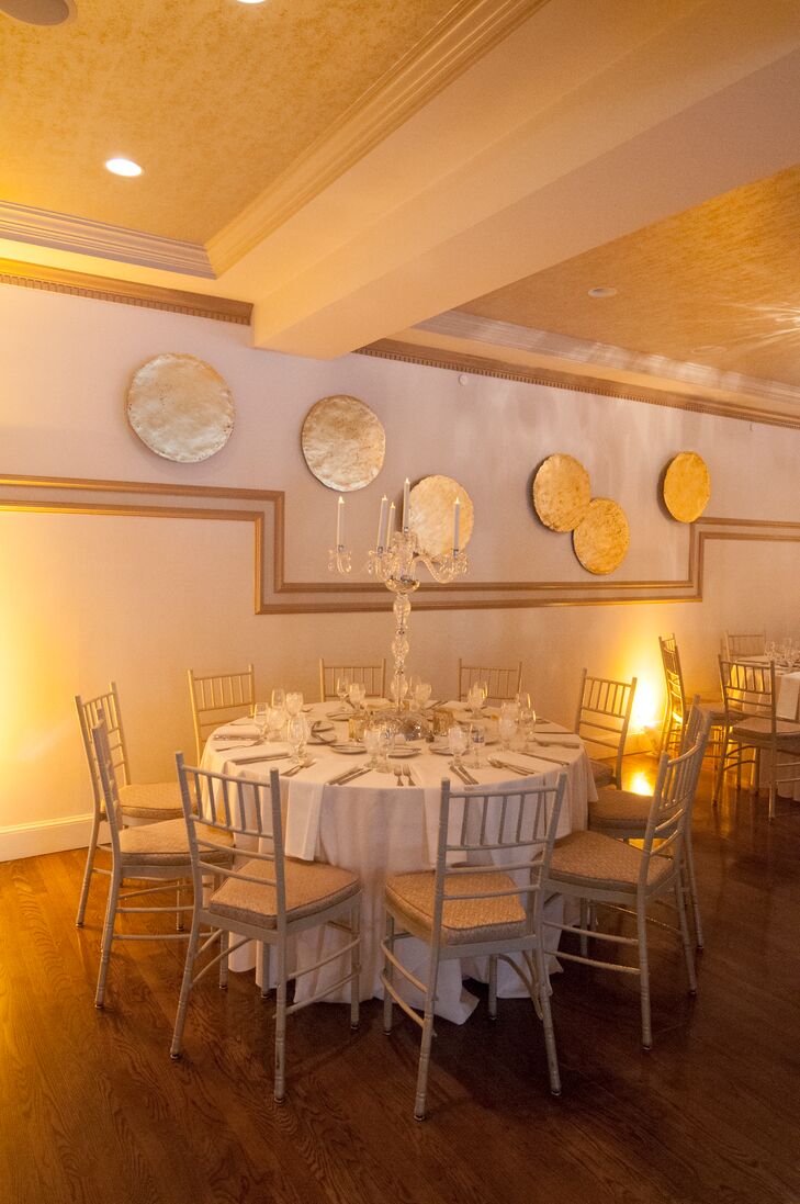 The couple and their guests moved inside for the reception, enjoying a night of dinner and dancing in the Saphire Estate’s elegant ballroom. With the help of Shane Hassey of Reserve Modern Event Rental, Diseanna and Luke transformed the venue into a modern, romantic scene. Tables were topped with dramatic crystal candelabra centerpieces, silvery mercury glass candleholders and crisp, ivory linens. “Lighting was key in the reception since we were going for a romantic candlelit look,” says Diseanna. “The tablescapes and place settings were kept to ivory linens with classic glass stemware so as not to take away from the dramatic centerpieces throughout the room.”