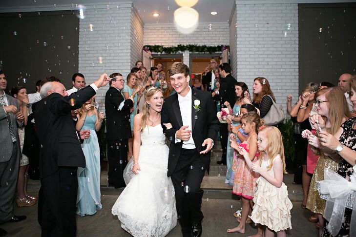 Sara Beth wore a Madeline Gardner strapless lace gown as the happy couple ran through family and friends blowing bubbles.