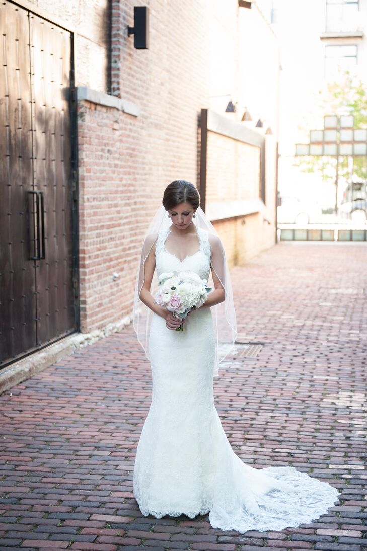 The bride wore a white lace dress by Marisa with a keyhole back along with a veil that was worn by two of her cousins before her. "Both of them stood up in the wedding, which made it very special," she says.