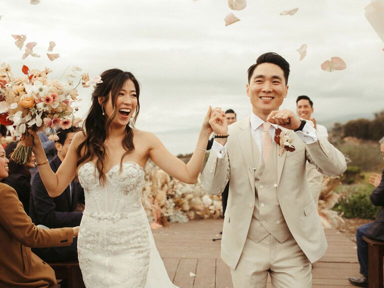 Bride and groom joyful outdoor wedding recessional