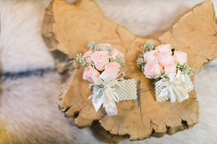 Small bunches of pastel pink roses were tied with a white satin ribbon for the romantic boutonnieres.