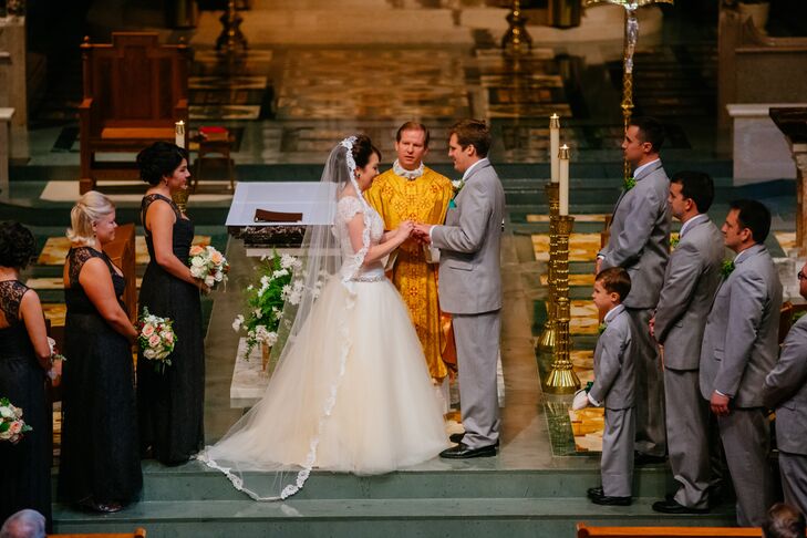 Inside the Cathedral of St. Joseph in Wheeling, West Virginia, Anna and Brandon were married in a traditional ceremony. Anna wore a gorgeous floor-length tulle veil trimmed with lace, attached to her elegant updo hairstyle.