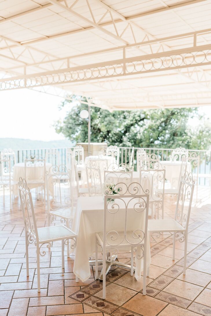 Patio Wedding Reception With White Tables and Metal Chairs