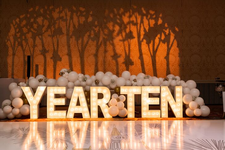 Marquee Lettering Accented by White Balloons in Front of Custom Reception Dance Floor