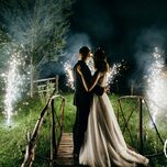Bride and groom watching fireworks at end of wedding day