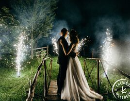 Bride and groom watching fireworks at end of wedding day