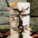 The three-tier, white fondant–covered confection was decorated with branches, butterflies, and flowers.