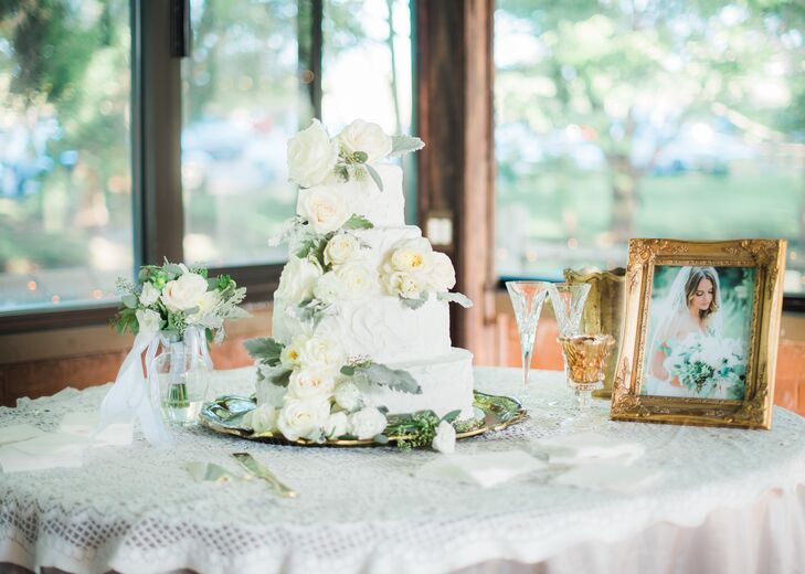 A four-tier cake frosted in buttercream icing was garnished in cascading flowers and was perched on a vintage brass cake stand that belonged to Derik’s grandmother. The cake table was dressed in a crocheted vintage tablecloth from Michelle’s grandmother.