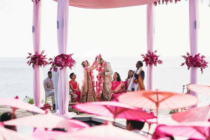Melanie and Neeraj exchange garlands, a key component of the traditional South Indian ceremony. The garlands represent their consent to be married to each other. The ceremony took place under a draped mandap of blush fabrics.