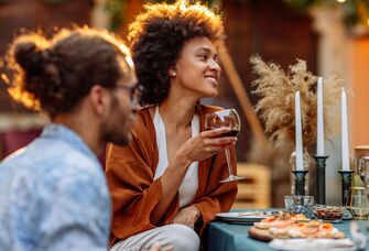 Couple dining outdoors with outdoor wedding registry items