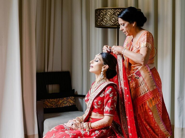 Mother helps prepare her daughter for her wedding day. 