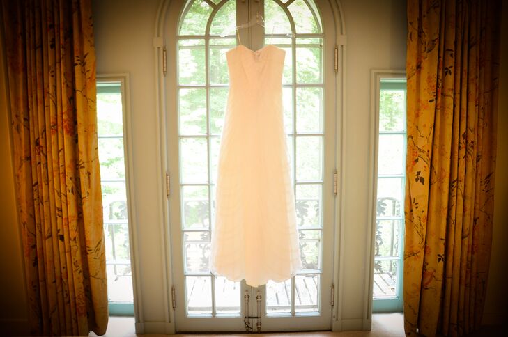 Christine wore a simple strapless dress on the day of the wedding, which was purchased from Brides by the Falls. Christine wore her dress with a sage green silk sash, which she wore to match Mike's sage green tie. To add a natural touch, Christine wore a flower crown of yellow roses mixed with baby's breath.