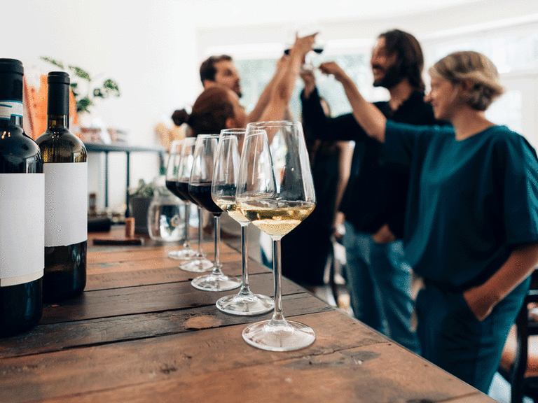 Friends at a wine tasting for their coed party.
