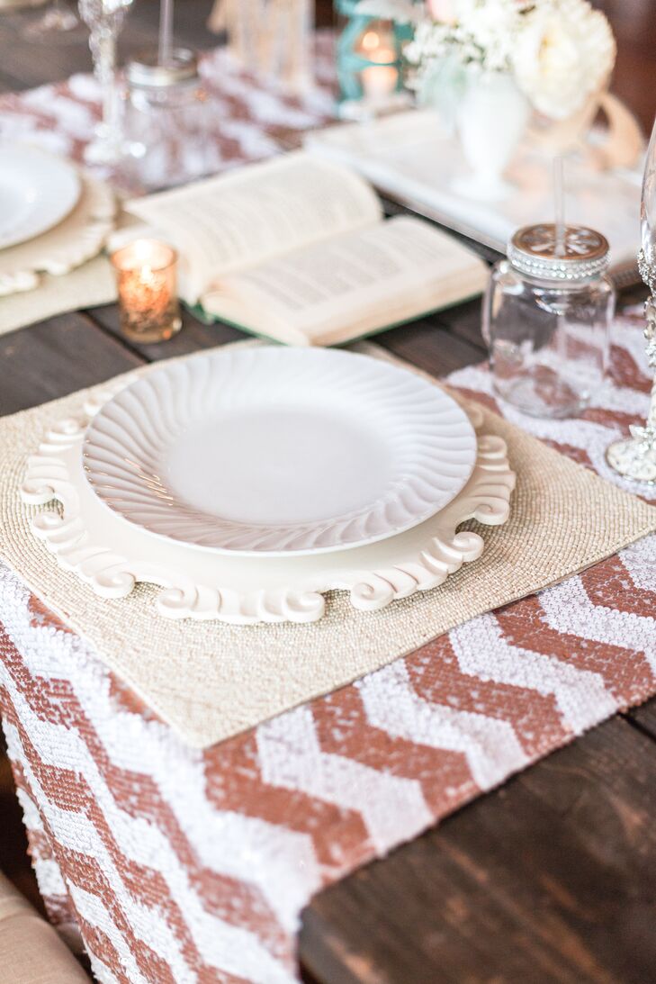 The sweetheart table place settings had a vintage plate and charger atop a glittery copper chevron runner.