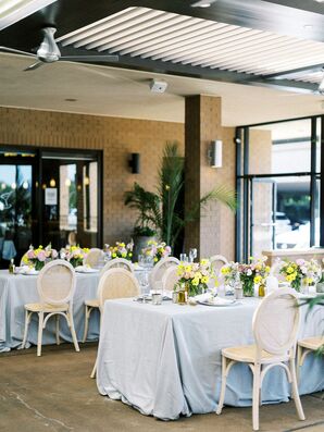 Tables With Blue Linens and Low, Bright Flowers for Italian-Themed Rehearsal Dinner