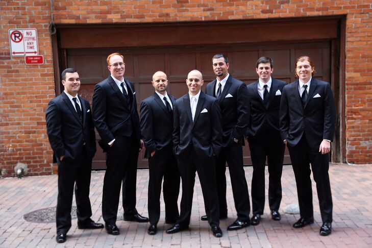 Keith and his groomsmen wore classic black tuxedos. Keith wore a white tie while the 'men sported black neckwear.