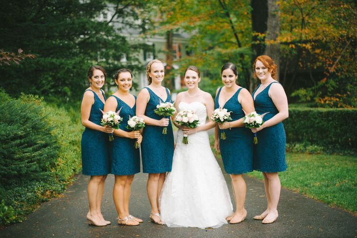 Emily's bridesmaids wore matching knee-length navy blue lace dresses with V necklines from J.Crew.