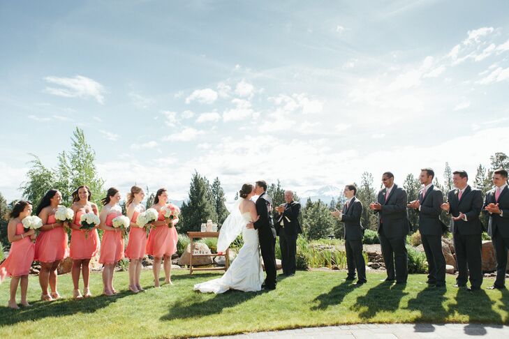 The bridesmaids wore strapless knee-length coral dresses in one of two styles chosen by Kellie. The groomsmen matched the bridesmaid apparel with coral ties, in addition to their charcoal suits.